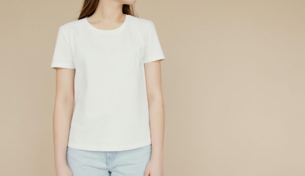 pexels-photo-6786614-6786614 Mockup of a woman in a white t-shirt and jeans on a beige background, ideal for fashion branding.